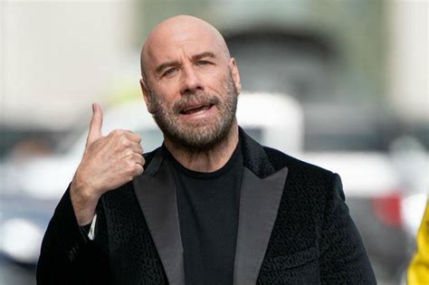 Bald John Travolta encouraged by Pitbull