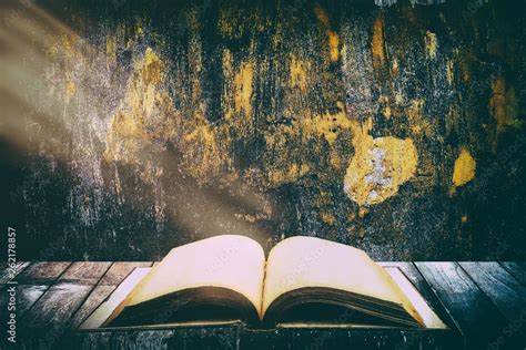 Old Vintage Holy Bible Opened on The Wooden Table with Grunge Concrete Wall Texture Background ...