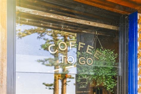 Image of Coffee shop window with reflection of trees - Austockphoto