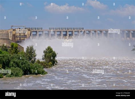 Vaal dam wall with mist from water gushing out of open sluices Stock ...