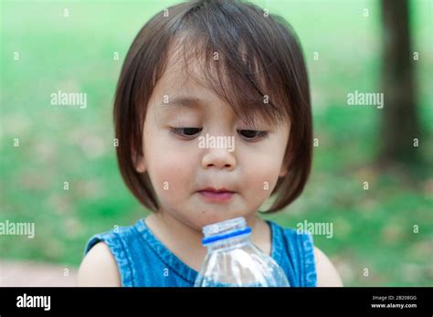 Asian toddler girl drinking water from the plastic water bottle Stock Photo - Alamy