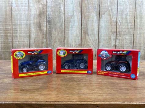 (3) 1/32 New Holland Tractors NIB Britains - Aumann Auctions, Inc.