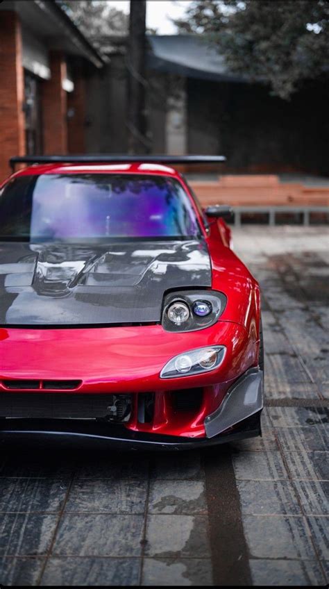 a red sports car is parked on the street