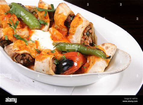 Wrapped Beyti Kebab with yoghurt and sauce Stock Photo - Alamy