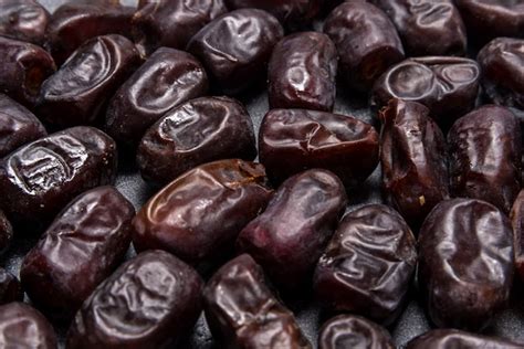 Premium Photo | Black dates healthy dried fruits