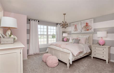 Striped gray walls and pink decor are the perfect match in this ...