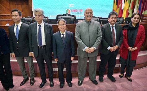 Caretaker Minister for Information and Broadcasting, Murtaza Solangi in a group photograph with ...