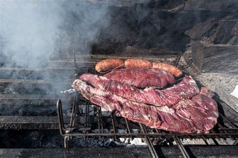 Typical Uruguayan and Argentine Asado Cooked on Fire. Entrana and Vacio Meat Cuts Stock Image ...