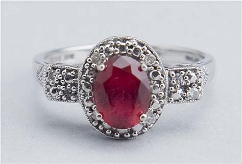 Sold at Auction: 10KT bixbite (red beryl) and diamond ring.