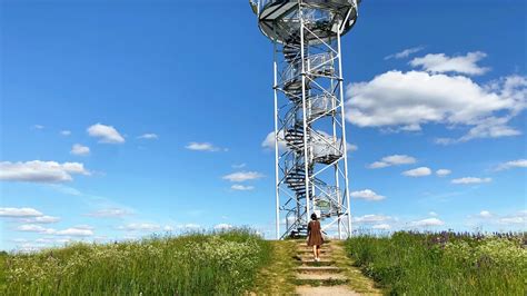 Woman tourist by Spiral staircase of lookout tower, construction with ...