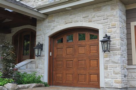 Traditional wooden garage doors and coach lights enhance this weathered-looking Everest Building ...