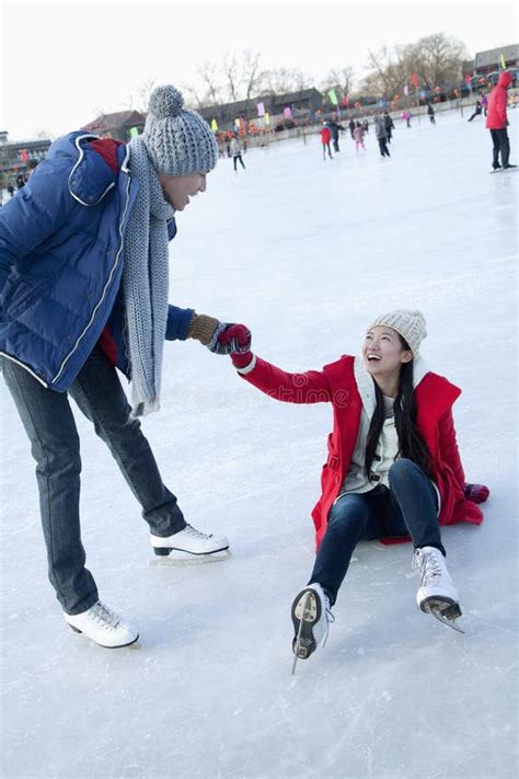 Young Woman Falls on the Ice while Skating, Boyfriend Helps Her Up ...