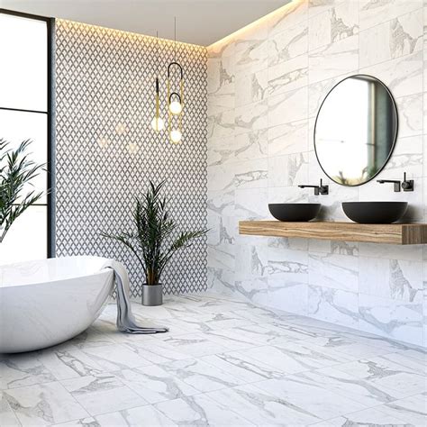 a bathroom with two sinks and a bathtub next to a large wall mounted mirror