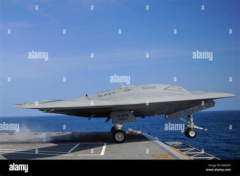 A US Navy X-47B unmanned combat air system drone launches from the ...