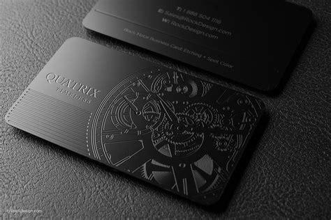 two black business cards sitting on top of a table next to each other, one with an image of a watch