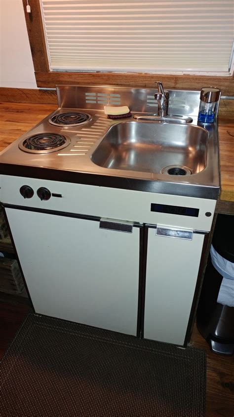 This tiny home's combination sink/stove/fridge that saves a ton of ...