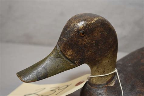 Antique hand carved wooden duck decoy with glass eyes, 12 1/2" in length and 6" high