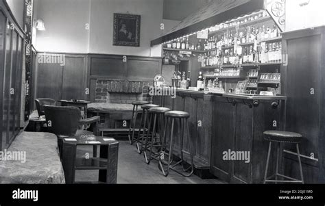 1950s, historical, inside view of small, wood panelled snug pub bar ...