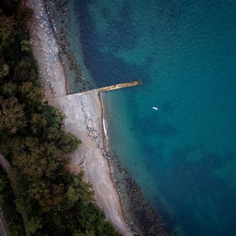 Aerial View of Blue Sea with Shore Dock · Free Stock Photo