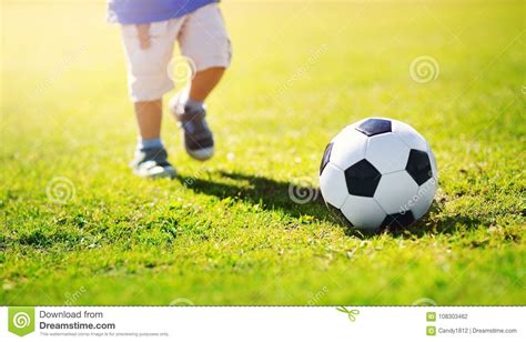 Little Boy Playing Football on the Field with Gates Stock Photo - Image ...