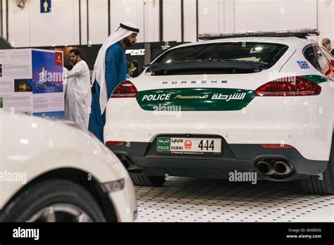 Dubai, UAE. A man looks at a Porsche Dubai Police car on the opening ...