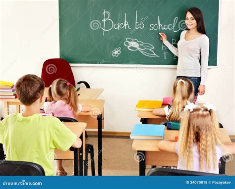 Teacher Writting At Blackboard In Classroom Royalty Free Stock Photos ...