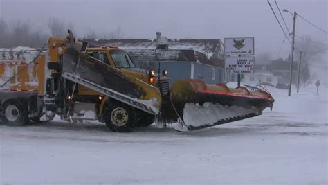 SPRINGHILL, NOVA SCOTIA, CANADA - FEBRUARY 9 2013 - Snow Plow Turning On To Rural Highway Taking ...