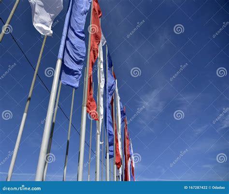 Lots of Flags Flying in the Wind Against the Blue Sky Stock Photo - Image of flutter, element ...