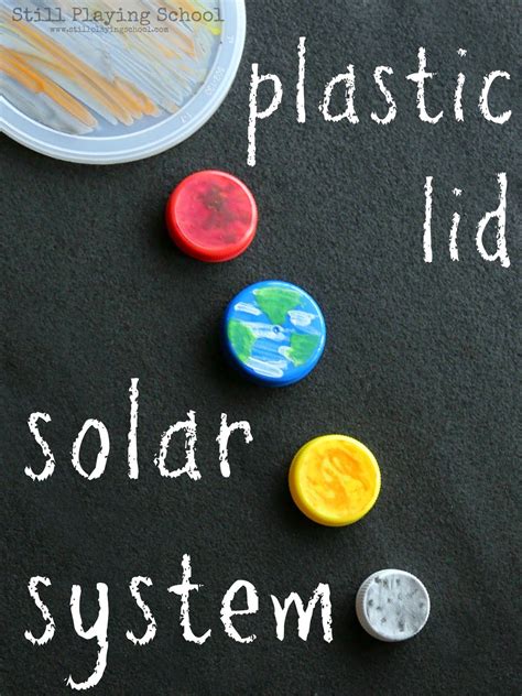 a chalkboard with plastic buttons and the words solar system written on it