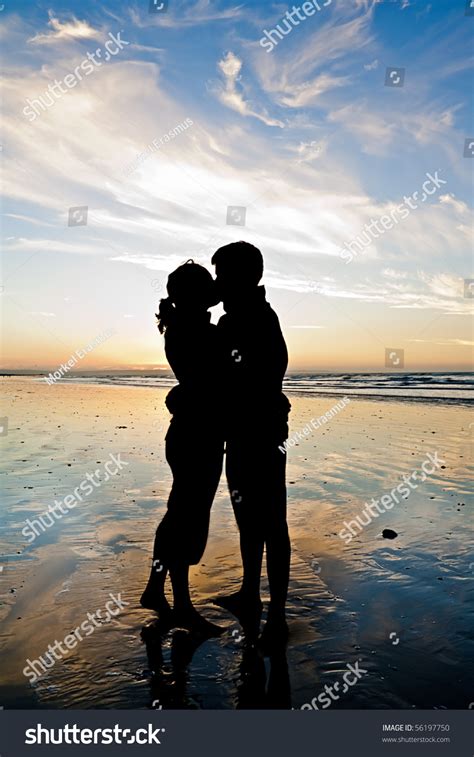 Silhouette Of A Young Couple Madly In Love Kissing On An Empty Beach Stock Photo 56197750 ...