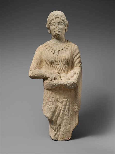 Limestone statuette of a female votary holding pieces of fruit ...