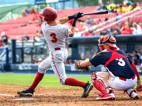 baseball player hitting and sliding - Pro Baseball Insider