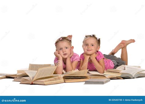 Two Nice Little Girl Lying on Pile of Books Stock Image - Image of ...