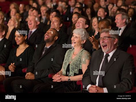 Laughing theater audience Stock Photo - Alamy