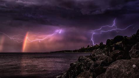 A rainbow in front of an impressive thunderstorm | Rainbow, Lightning, Photo