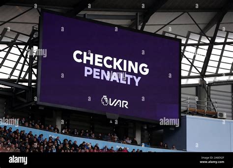 A VAR decision is displayed on the big screen as they check a penalty ...