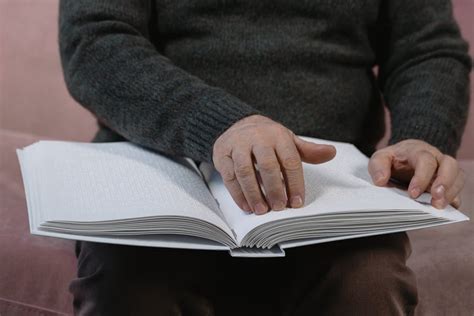 A Blind Person Reading a Braille Book · Free Stock Photo