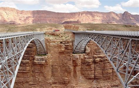 Two almost identical steel-arch bridges span the canyon. A parking area is on the other side ...