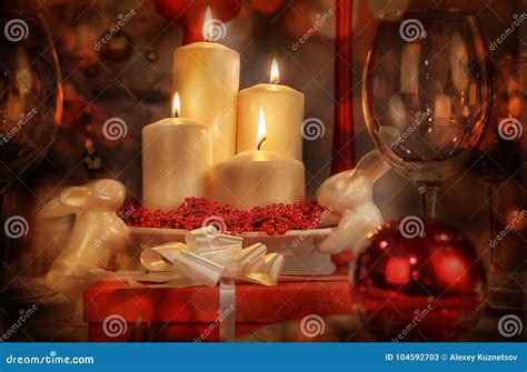 Lit Candle and Christmas Gift Stock Image - Image of glasses, christmastime: 104592703