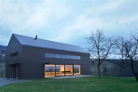 arhitektura d.o.o. reinterprets vernacular farmhouse with black barn