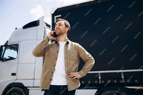 Premium Photo | Truck driver standing by his lorry