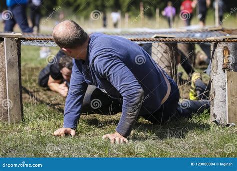 Muddy Obstacle Race Runner in Action. Mud Run Editorial Stock Image - Image of obstacle, feet ...