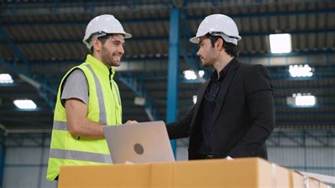 Premium Photo | Two factory workers working and discussing manufacturing plan in the factory ...