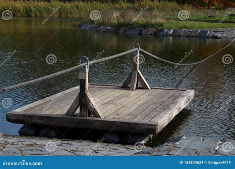 Wooden Raft with a Rope on a Pond Stock Photo - Image of floating, equipment: 163890624