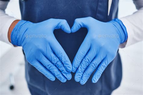 Heart emoji, hospital and hands of doctor for medicine, surgery and working in clinic for ...