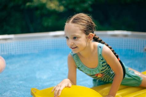 Premium Photo | Little girl lying on pool float