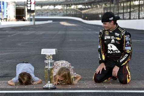 Jeff Gordon with his kids, Leo and Ella, kissing the bricks after winning the 2014 Brickyard 400 ...