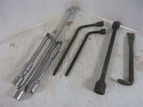 Folding heavy duty steel lug wrench with four sizes, (2) Tire irons, Crowbar, and Steel breaker ...