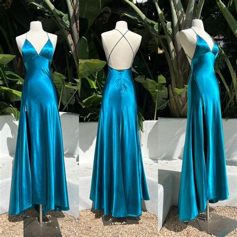 This teal blue satin dress is inspired by Elvira... - Depop