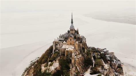 Aerial top view, drone flying above amazing Mont Saint Michel Abbey ...